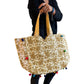 Bolso bohemio dorado con pompones