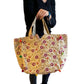 Bolso bohemio dorado con pompones